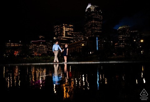 A newly engaged couple's blissful walk in North Carolina along the reflecting water at night