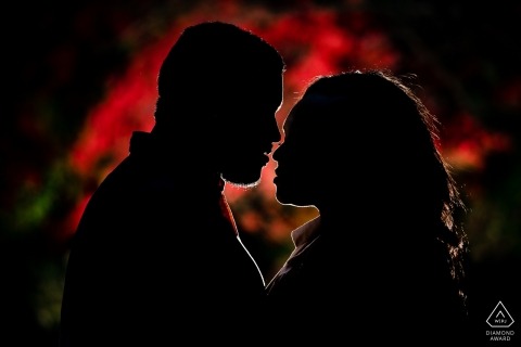 A North Carolina newly engaged couple is illuminated by a vibrant red light