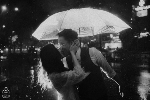 engagement photograph at Ho Chi Minh city Vietnam in the Rain with Umbrella