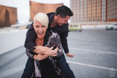 Las Vegas engagement portraits at the hotel parking lot | Let's Ride - she gives him a piggyback ride in the city 