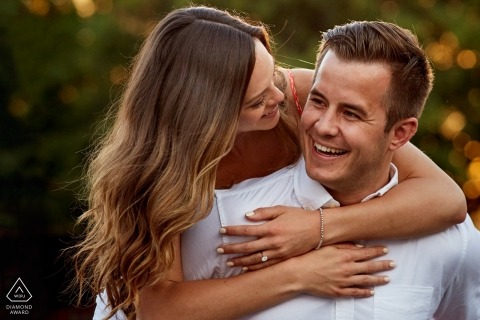 This Enagaged couple share a moment as he carries her around the Old Town Square at sunrise 