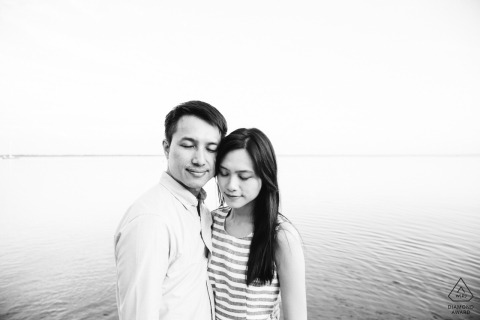 Lacanau, south west of France - A couple feeling their love during black and white engagement photo session at the water