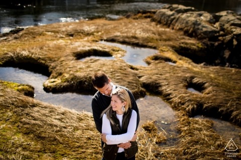 Cohasset, MA Couple in saltwater marsh posing for engagement photos.