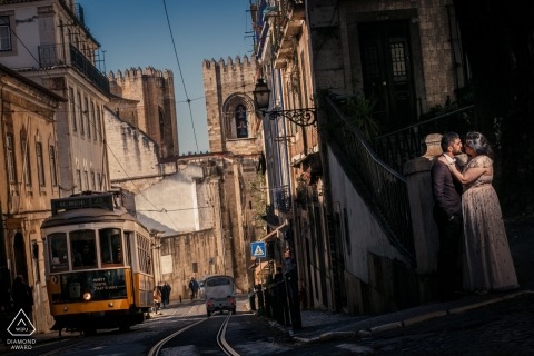 Alfama, Portugal Engagement Photography - Portrait contains: cable car, trolly, streets, train, light, sun