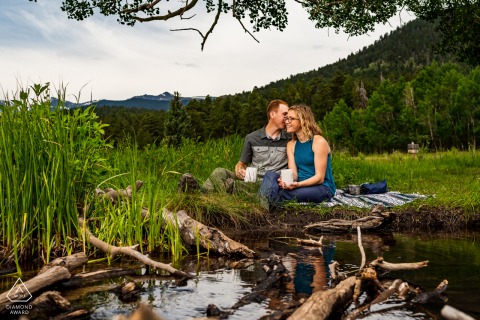 CO pre wedding portrait session with engaged lovers at the Rocky Mountain National Park showing a Couple enjoying coffee together in RMNP