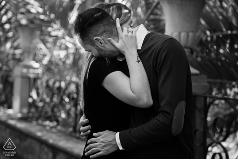 Andalusia engagement photo shoot with a formal couple hugging in Granada, Spain