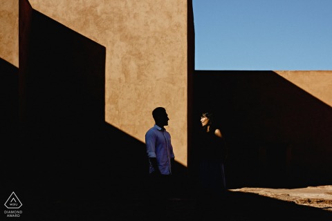 Africa engagement portrait with a posed couple in interesting light and a shadow geometric composition in Marrakech, Morocco 
