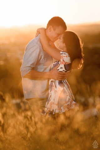 Australia pre wedding and engagement photography in Fossil Bluff, Tasmania, Australia of a couple in the long grass bathed in golden hour light 