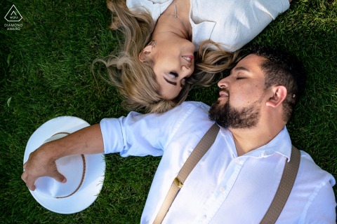 Volunteer Landing Park, Knoxville on-location portrait e-shoot - the couple lays on the park grass with their eyes closed enjoying the afternoon breeze
