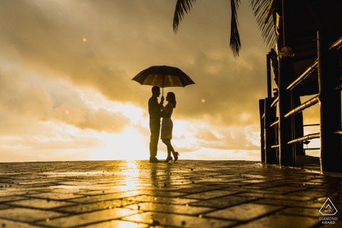 Maceió, Brazil environmental engagement e-session showing the sun, umbrella and a Silhouette of a couple
