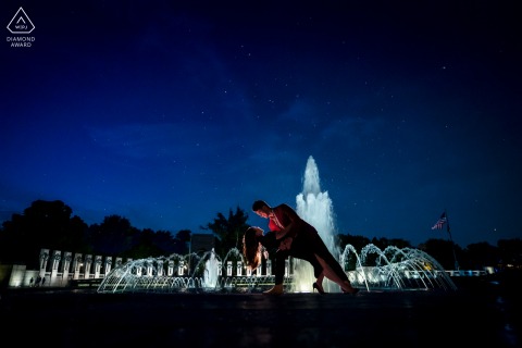 DC bride and groom to be, modeling for a pre-wedding picture at the WWII Memorial, a night portrait of the groom dipping his fiance in front of a big fountain