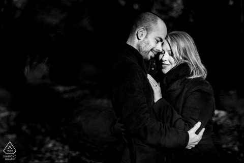 A Buckinghamshire Wedding, Elopement, and Engagement Photographer created this creative, black and white portrait of this Burnham Beeches couple holding each other with nice light on their faces A Buckinghamshire Wedding, Elopement, and Engagement Photographer created this creative, black and white portrait of this Burnham Beeches couple holding each other with nice light on their faces