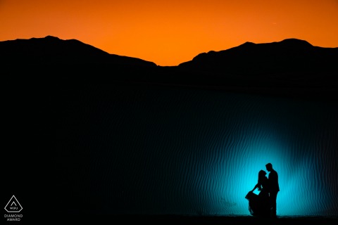 A Texas Wedding, Elopement, and Engagement Photographer created this creative, lit portrait of this TX couple posing as a silhouette at sunset at The White Sands National Monument