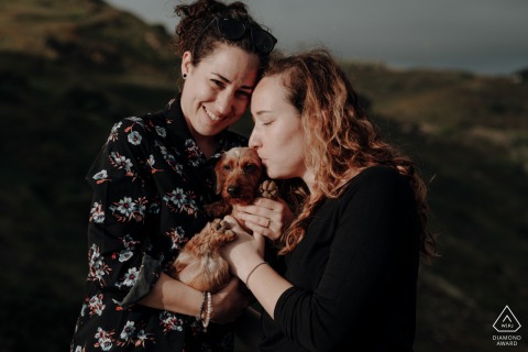 Cabo da Roca post proposal portrait photos of a happy Sintra couple embracing their best friend almost in the complete sunset Cabo da Roca post proposal portrait photos of a happy Sintra couple embracing their best friend almost in the complete sunset