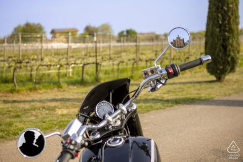 Castello Bonomi Engagement Photos. Franciacorta couple posing with a Castle reflection in the motorcycle mirror