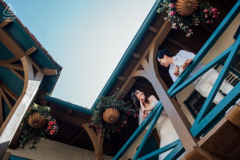 A San Francisco couple poses on a balcony for engagement announcement portraits in Northern California