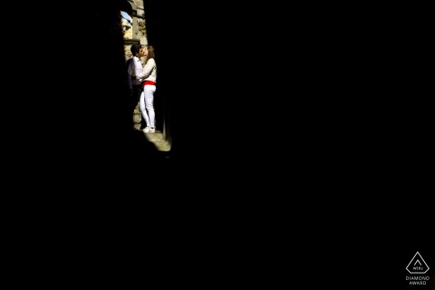 Iseo Lake nontraditional lifestyle engagement portrait of an Italian couple kissing in the Shadows and light