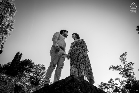 At Brescia Castle the couple walk and pose for a low angle black and white portrait