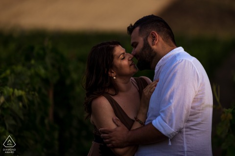 A Crotone - Calabria - Italy portrait of the couple in the vineyard sharing a kiss