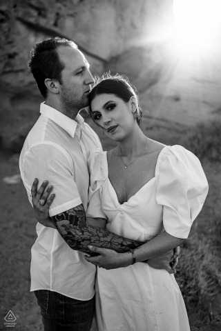 A black and white Valley of Fire Sunset and love portrait of a couple in the desert light near rocks