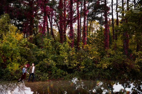 A MN Couple is walking in fall colors during their St. Paul engagement portrait session