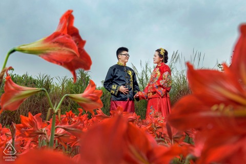 A couple in a beautiful flower-filled field in Fuzhou, China are glowing with excitement as they prepare to tie the knot