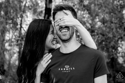 The delightful pre-wedding black and white photograph of the couple at Sevilla, Spain with her hand covering his eyes and big smiles on their faces captures the unique joy of their lifestyle engagement portrait session