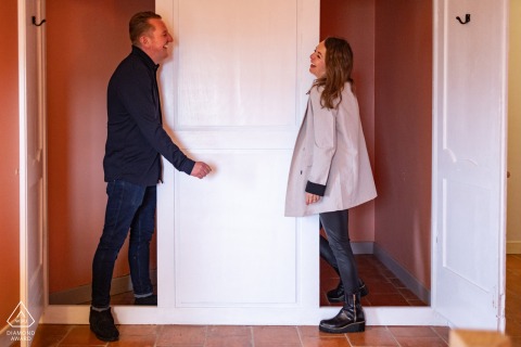 The Castelnau, Lectoure, Gers, France: Playful Couple Poses Happily in Closet-Style Cupboards The couple posed happily in The Castelnau, Lectoure, Gers, France, engaging in playful antics while hiding in and peeking out of the closet-style cupboards