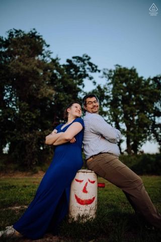 In the engagement portrait taken at Budapest Szúnyog sziget, the couple can be seen sitting back-to-back on a barrel
