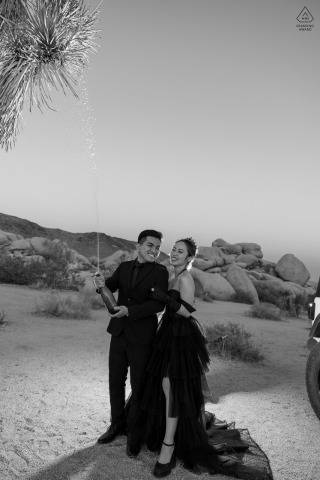 This romantic portrait captures a couple in Joshua Tree National Park, at the end of their photoshoot, as they unwind and relax before their wedding day.