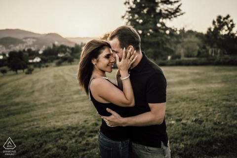 At Schlösser Gutenberg in Lucerne, this engagement shoot captures the couple at golden hour. The scene features a tender embrace and face touching on the grass field, creating a warm and romantic atmosphere.  - Golden Hour Embrace