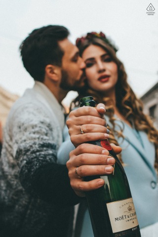 Set in the charming Beijing Wudaoying Hutong, this engagement photo captures the essence of champagne love with the couple close together holding a bottle with ring hands, exuding relaxed energy.
