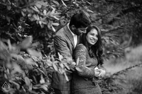 Engaged couple's black and white portrait at Bluff Trailhead in Gualala, CA, showcasing their love amidst the natural beauty of monochromatic foliage.