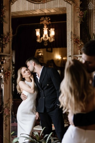 At the Grand Hotel de Londres in Istanbul, a couple embraces indoors with their reflection captured in a mirror, highlighting the timeless elegance and depth of their love.