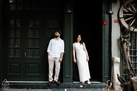 On Çukurcuma Street in Istanbul, a couple poses for a portrait in front of an antique shop. The quaint setting adds charm and character.