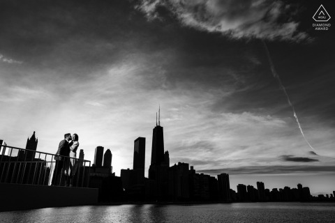 A couple shares a tender embrace at Milton Olive Park as the Chicago skyline glows at sunset.
