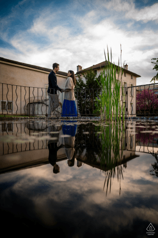 A couple joyfully embraces by a pool of water in Charly, France. 