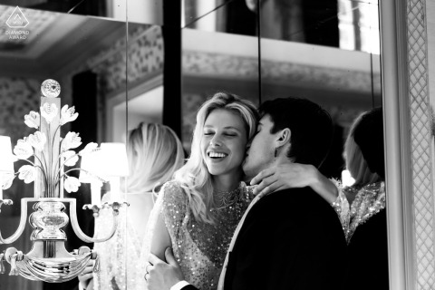 Joyful Engagement Amidst Soft Lighting in a Paris Hotel Room A couple shares an intimate, joyful moment in a cozy Paris hotel room, surrounded by soft lighting and elegant decor.