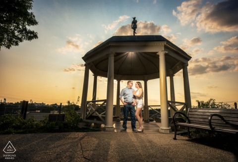 The couple pose during the golden hour at Fairmount Waterworks, bathed in soft, golden light.