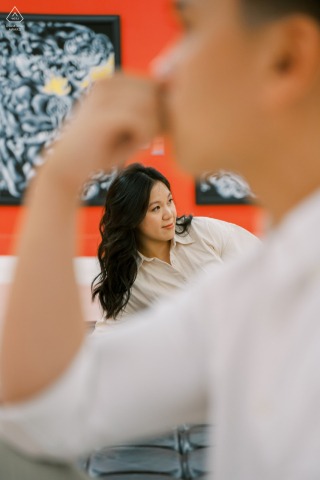 At Bangkok's MOCA Museum, the couple admires artwork, captivated by vibrant colors and creative expressions in the gallery.