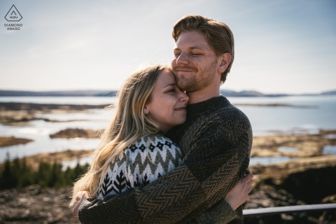 Couple embraces lovingly by a serene lake on Iceland's south coast, surrounded by breathtaking natural beauty and tranquility.