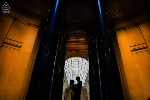 The silhouetted couple enjoy the archways' expansive beauty at the National Portrait Gallery, capturing their engagement session joyfully.