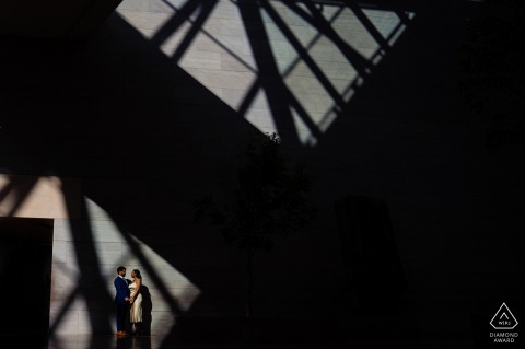 At the National Gallery of Art, DC, a couple enjoys an engagement session bathed in fascinating light and shadow patterns.