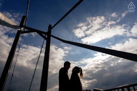 Silhouetted couple embraced during a winter engagement photo shoot in Verdun, France’s chilly landscape.