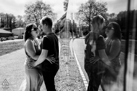 In Verdun, France, a creative pre-wedding shot captures a couple with their reflection elegantly mirrored on the wall.