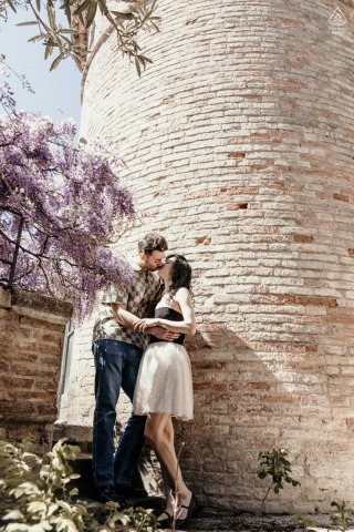 Portrait of Couple in Ravenna City Center, Surrounded by Flourishing Wisteria Garden Blooms Couple poses for a portrait in Ravenna’s historic city center, surrounded by flourishing wisteria garden blooms.