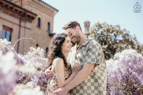 Engaged Couple in Ravenna Garden, Blooming Wisteria and Historic Architecture Surround Their Love Engaged couple in Ravenna garden, surrounded by blooming wisteria and historic architecture.