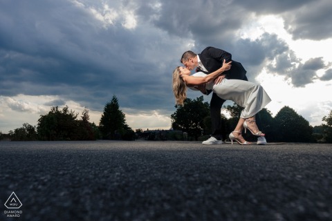 Engaged couple, the engaged couple share a perfect dip kiss outside Philadelphia Museum of Art, skyward gaze.