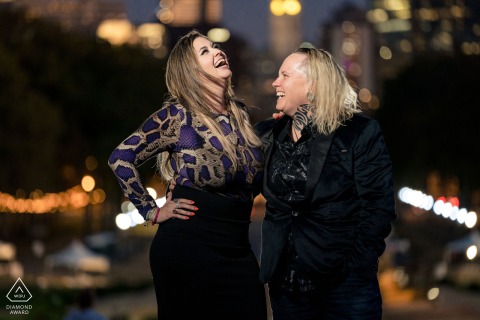 The couple share joyful laughter and pure love against the vibrant Philadelphia cityscape backdrop.