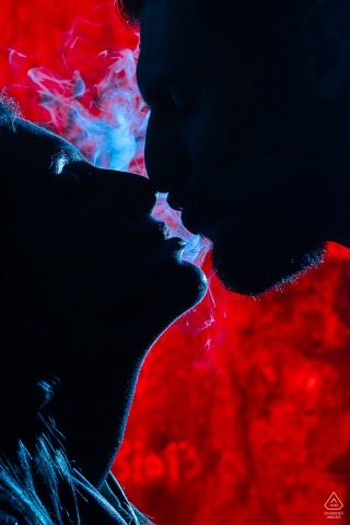Silhouette of lovers embracing in Sassenage, France, with soft natural light enhancing their romantic connection.